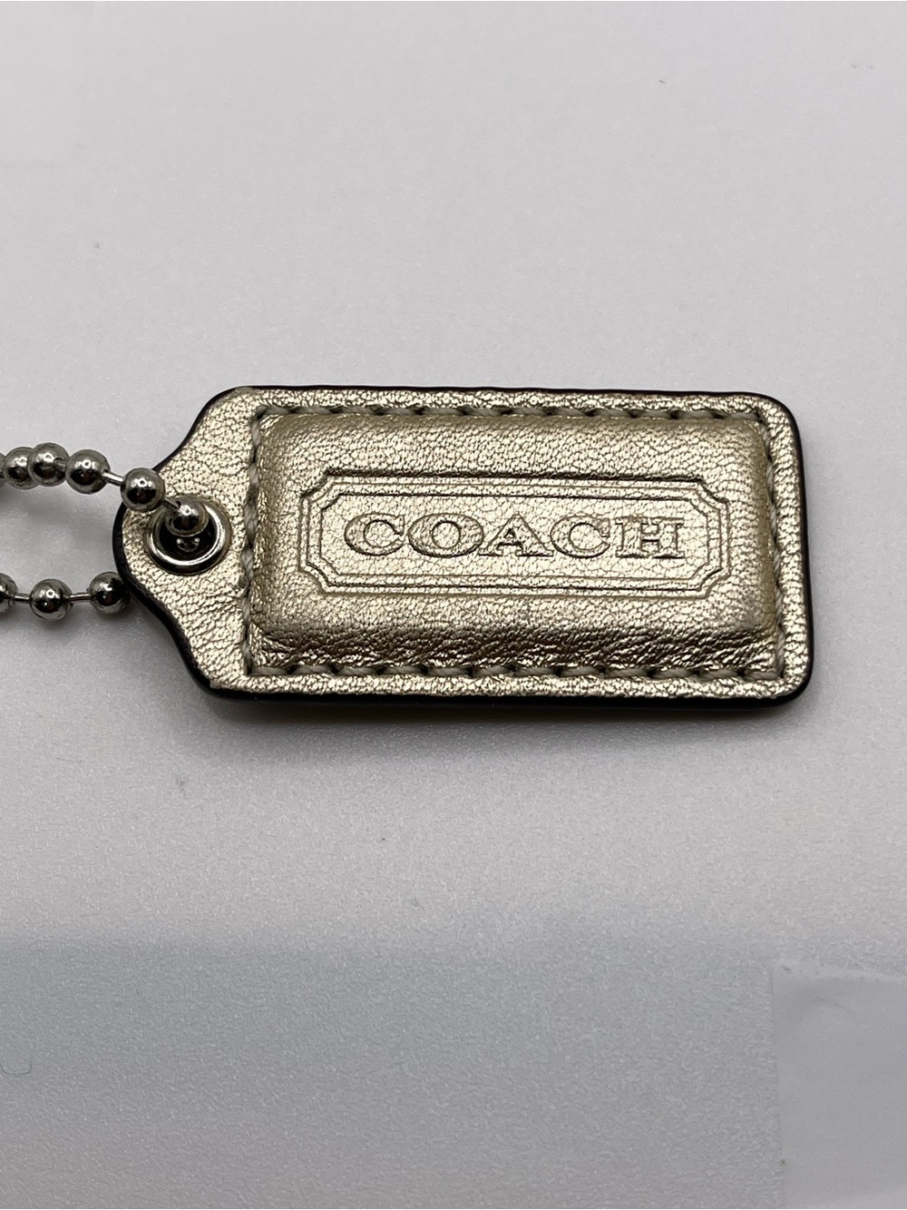Coach Poppy Metallic SILVER Leather Hang Tag